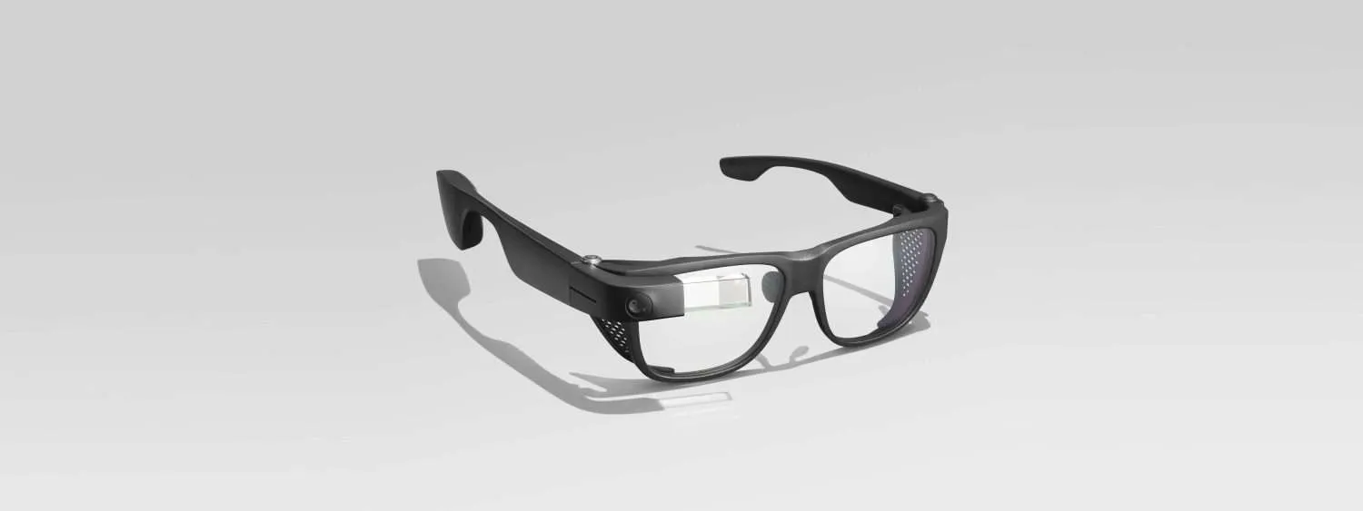 Black smart glasses with built-in display and camera on a white background.